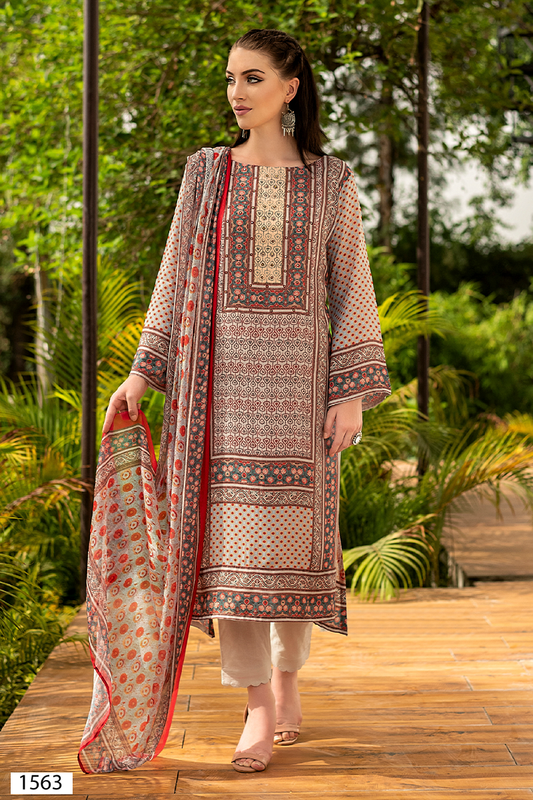 A woman modeling a traditional three-piece suit set in an outdoor garden setting. The suit features a beige suit with intricate multicolor geometric patterns, matching patterned trousers, and a coordinating dupatta with a red border. | Wholesale Beige Ethnic Muslin Suit Set | Sri Fashion
