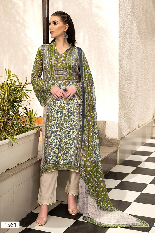 A woman models a traditional three-piece suit set in olive green, featuring intricate floral prints, beige trousers, and a matching dupatta, set against a modern architectural background with a black and white checkered floor. | Wholesale Olive Green Ethnic Muslin Suit Set | Sri Fashion
